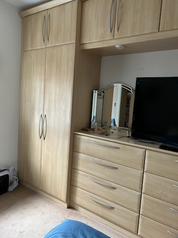 Light oak fitted wardrobes and drawer units before strip-out