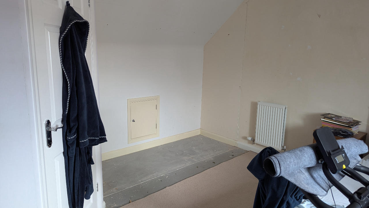 The same bedroom wall cleared and left sound and ready after the fitted wardrobes were removed