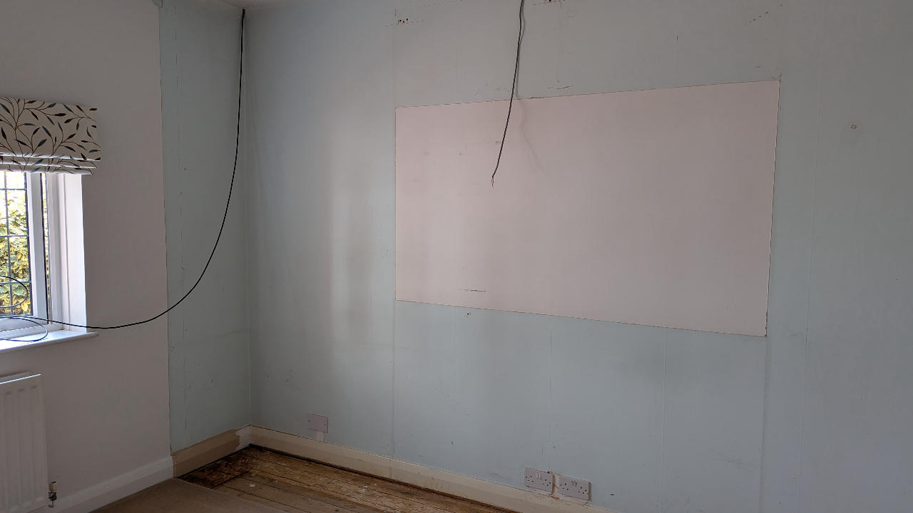 Wall left ready with fresh plasterboard after fitted furniture removal
