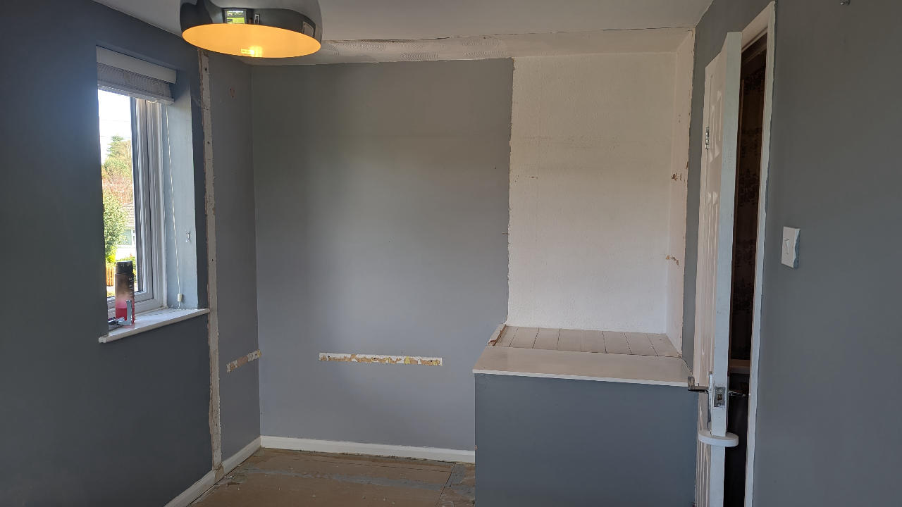 The same room cleared and swept, walls and floor left ready for the new install